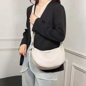 Stylish crescent shoulder bag for women, versatile crossbody dumpling bag with wide strap detail.