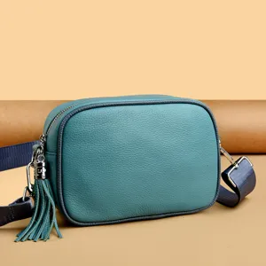 Genuine leather small square crossbody bag with tassel and wide strap for women daily use.