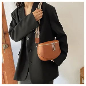 Genuine leather saddle bag detail, premium cowhide texture, stylish striped strap.
