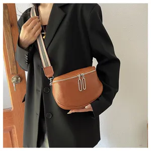 Trendy genuine leather women saddle bag with classic striped shoulder strap and dual metal zippers.