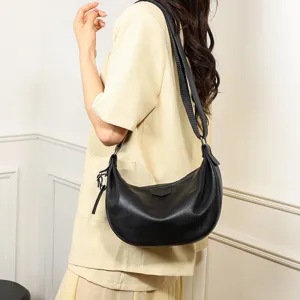 Detailed view of women black leather crossbody shoulder bag, versatile dumpling bag for daily commuting.