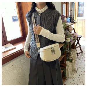 Trendy genuine cowhide leather saddle bag for women with stylish wide crossbody strap.