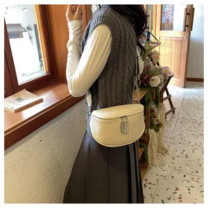 Women's genuine leather saddle bag with wide strap and double zipper, chic shoulder crossbody.