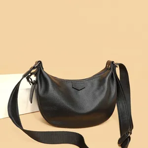 Close-up view of the black leather hobo bag showcasing texture and wide strap design.
