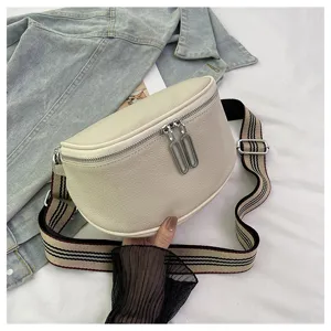 Genuine leather saddle bag for women, stylish crossbody shoulder bag with wide striped strap.