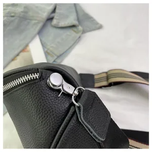 Detail view of black genuine leather saddle bag, showing premium cowhide and metal hardware.