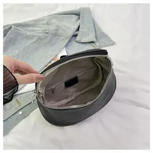Detail view of the black genuine leather saddle bag interior structure and zipper.
