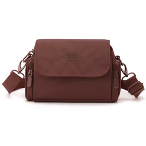 Casual solid color women's crossbody bag with front flap and zipper side pockets for daily use.