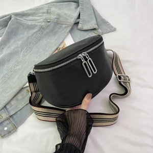 Black genuine leather saddle bag for women, stylish crossbody bag with wide striped strap.