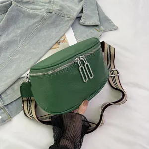 Green genuine leather saddle bag for women, stylish crossbody handbag with wide woven strap.