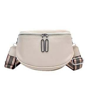 Chic genuine leather saddle bag for women, stylish crossbody handbag with wide striped strap.