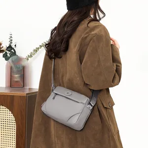 Grey nylon crossbody bag detail, casual daily shoulder bag, lightweight water resistant fabric.