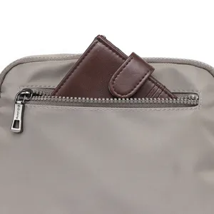 Close-up detail of women's casual nylon crossbody bag with zipper pocket and cardholder.