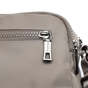 Casual nylon crossbody bag detail showing durable metal zipper and water-resistant fabric.
