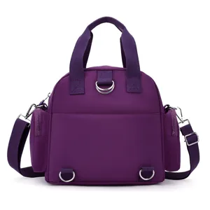 Purple nylon multi-functional convertible backpack handbag detail view with metal D-rings.