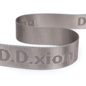 Nylon shoulder bag strap detail view, durable woven webbing with custom letter print accent.