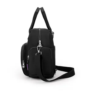 Side detail view of black nylon multi-pocket casual shoulder backpack with sturdy straps and zippers.