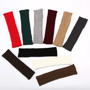 Detailed view of knitted arm warmers in various solid colors, soft winter accessories.