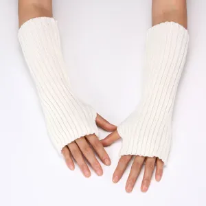 White knitted arm warmers detail close-up shot, soft ribbed design for winter warmth.