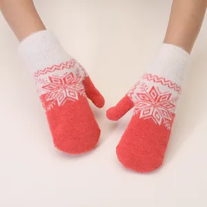 Winter knitted mittens detail view, cozy rabbit hair blend with classic snowflake pattern.