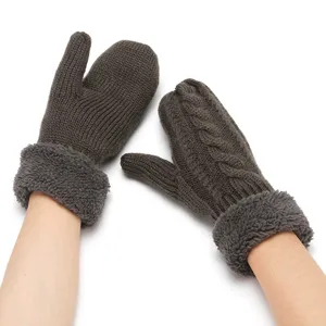 Close up of dark grey knitted mittens with fuzzy cuffs, warm winter hand wear details.