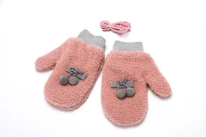 Cute pink fuzzy winter gloves with grey pom poms and warm fleece lining for cold weather.