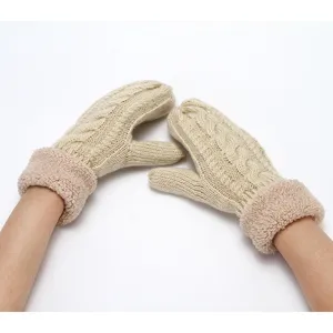 Detail view of fleece lined cable knit mittens showing soft plush cuff and warm winter texture.