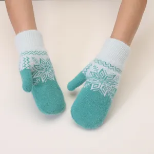 Close-up of cozy winter knit mittens with classic snowflake patterns and fuzzy texture.