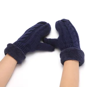 Close-up detail of thermal cable-knit fleece-lined mittens in navy blue for cold winter days.