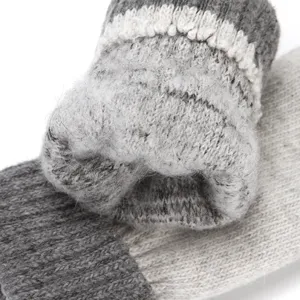 Close-up of cozy knitted winter gloves detail showing soft fuzzy texture and warm wool blend.