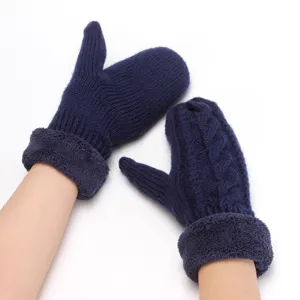 Detail shot of navy blue cable knit fleece lined mittens showing plush warm cuffs clearly.