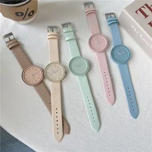 Detailed flat lay view of colorful macaron silicone quartz student watches on a clean white surface.