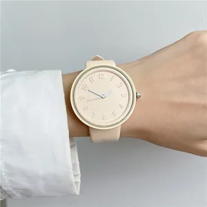 Beige silicone student watch with embossed dial numbers and slim hands, minimalist daily wear.