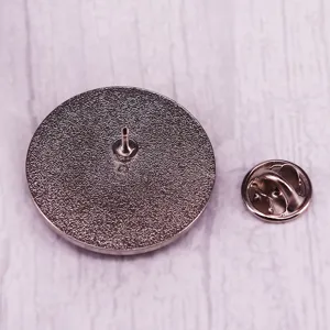 Metal astronaut spaceship badge back view detail showing secure pin clutch fastener.