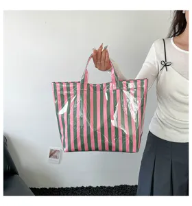 PVC striped tote bag detail, glossy waterproof finish, pink and green vertical stripe design.