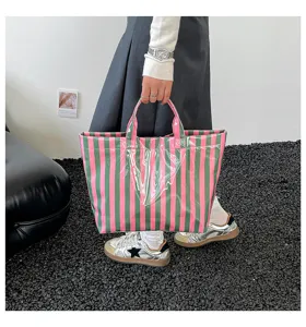 PVC striped large capacity tote bag for women, waterproof casual commuting shoulder handbag.