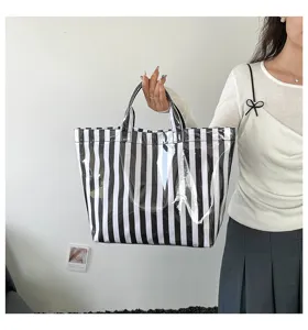 Close-up view of the black and white striped PVC tote bag showcasing fine details and texture.