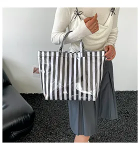 Black and white striped PVC tote bag for women, large capacity waterproof casual shoulder bag.