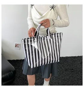 Details of the black and white striped PVC waterproof tote bag, showcasing large capacity.