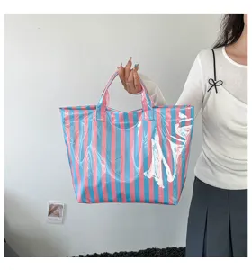 Details of the stylish pink and blue striped PVC tote bag, large capacity waterproof design.