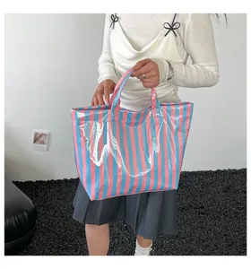Detailed view of the colorful striped PVC tote bag, showing its large capacity and stylish design.