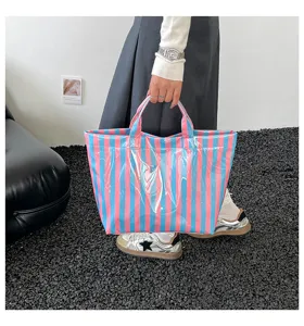 Detailed view of a stylish PVC striped tote bag, large capacity waterproof handbag for daily commute.