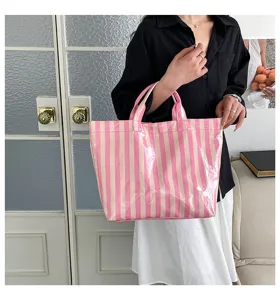 Pink vertical striped PVC tote bag, waterproof daily commute shoulder handbag detail view.