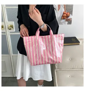 Detail view of pink striped PVC tote bag, large capacity, waterproof commuter handbag.
