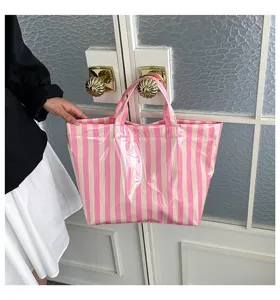 PVC striped tote bag detail showing pink white vertical pattern, waterproof and large capacity.