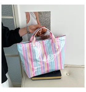 Detailed view of the colorful striped PVC tote bag, showing glossy waterproof texture and handle.