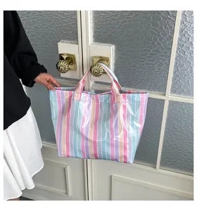 Waterproof PVC striped tote bag for women, large capacity stylish casual handbag for daily use.