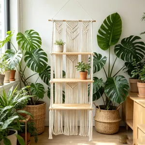 Detail view of bohemian handmade macrame wall hanging shelf with natural wooden tier boards.