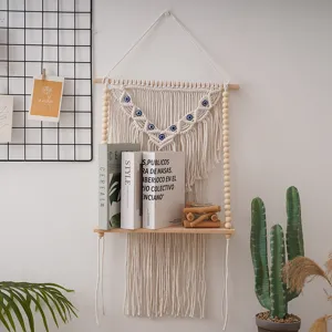 Bohemian macrame wall hanging shelf with wooden beads and evil eye decor for room decor.