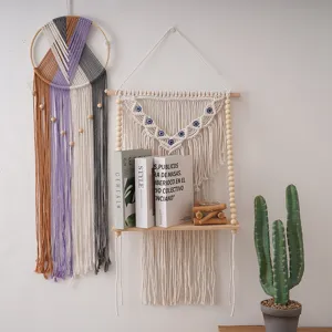 Bohemian handmade woven cotton rope wall hanging shelf with evil eye bead detail for room decor.
